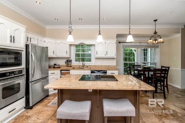 1509 Ridgeland Rd, Mobile, AL 36695 - kitchen featuring black appliances, white cabinetry, a kitchen island, and ornamental molding