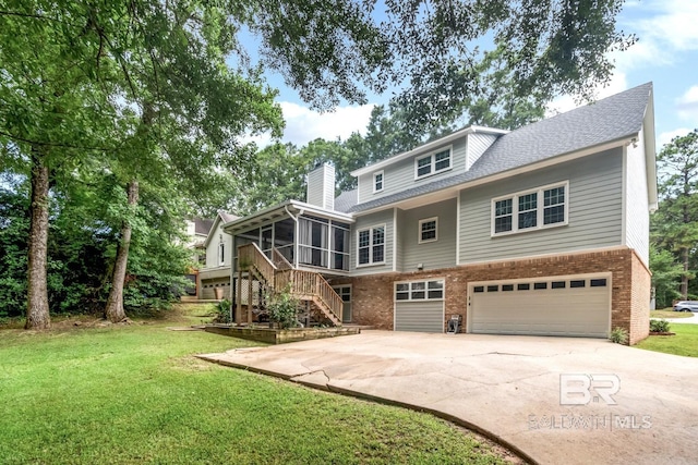 1509 Ridgeland Rd, Mobile, AL 36695 - rear view of house featuring a sunroom, brick siding, an attached garage, concrete driveway, and a chimney