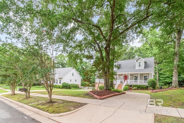 1509 Ridgeland Rd, Mobile, AL 36695 - new england style home with a porch, a front yard, stairway, and driveway