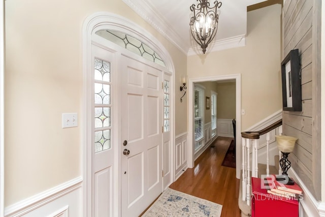 1509 Ridgeland Rd, Mobile, AL 36695 - foyer with crown molding, wood finished floors, a chandelier, wainscoting, and a decorative wall