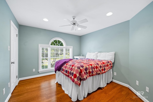 bedroom with ceiling fan and hardwood / wood-style floors