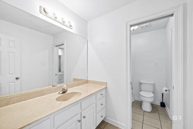 bathroom with vanity, toilet, and tile patterned floors