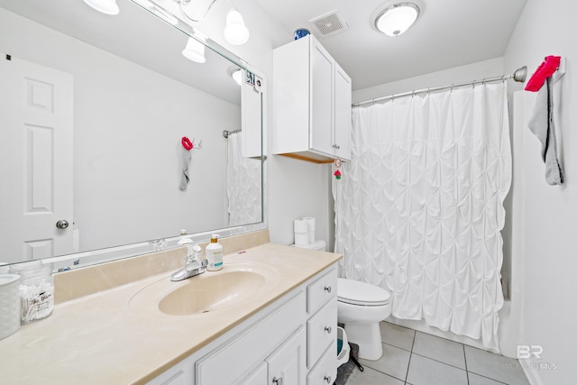 full bathroom with shower / bath combo with shower curtain, tile patterned floors, vanity, and toilet