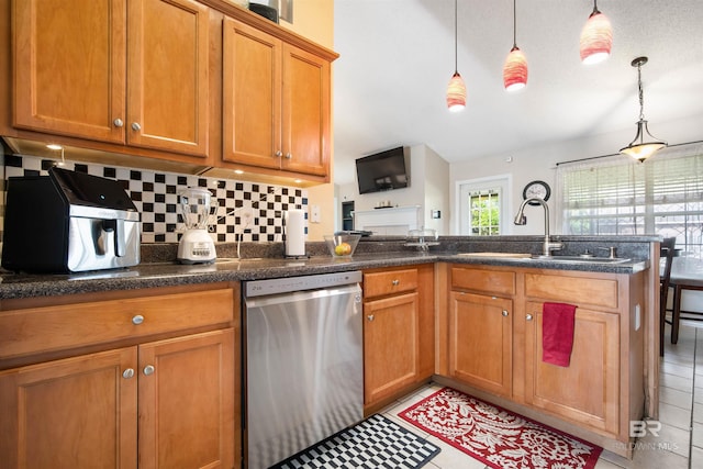 2856 W Saddlebrook Dr, Mobile, AL 36695 - kitchen with stainless steel dishwasher, a sink, decorative backsplash, a peninsula, and brown cabinetry