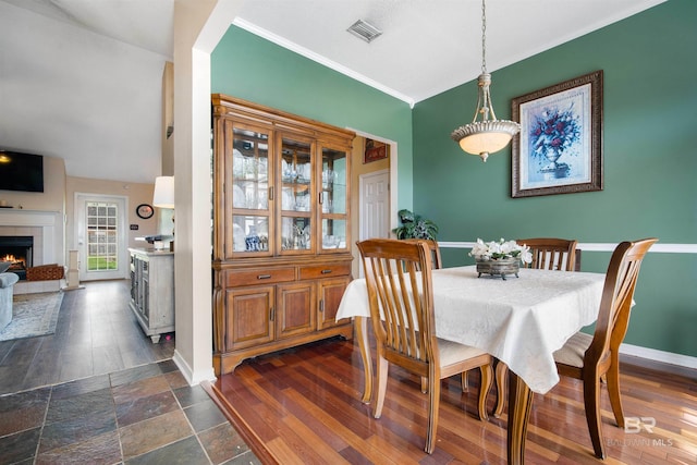 2856 W Saddlebrook Dr, Mobile, AL 36695 - dining room with a tiled fireplace, visible vents, baseboards, and ornamental molding