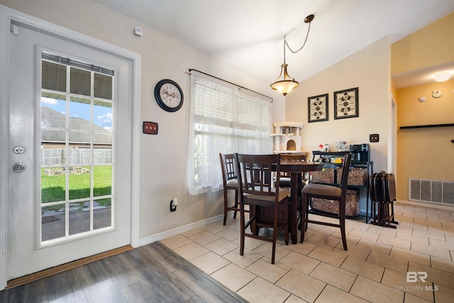 2856 W Saddlebrook Dr, Mobile, AL 36695 - dining area with vaulted ceiling, baseboards, wood finished floors, and visible vents