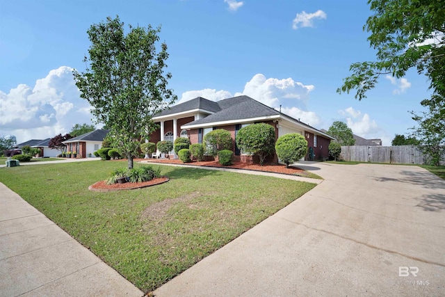2856 W Saddlebrook Dr, Mobile, AL 36695 - view of front of house featuring fence, an attached garage, a front yard, and concrete driveway