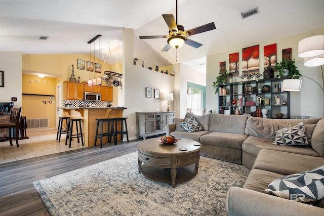 2856 W Saddlebrook Dr, Mobile, AL 36695 - living room with ceiling fan, lofted ceiling, wood finished floors, and visible vents