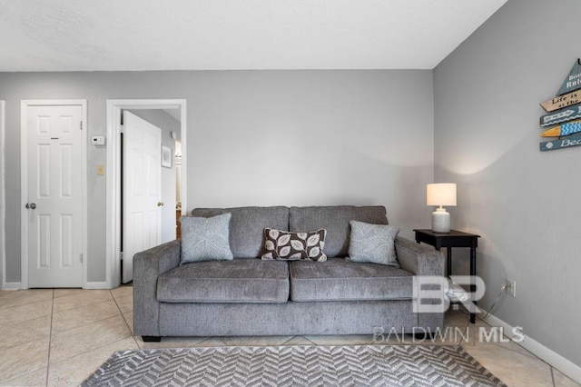 tiled living area with baseboards