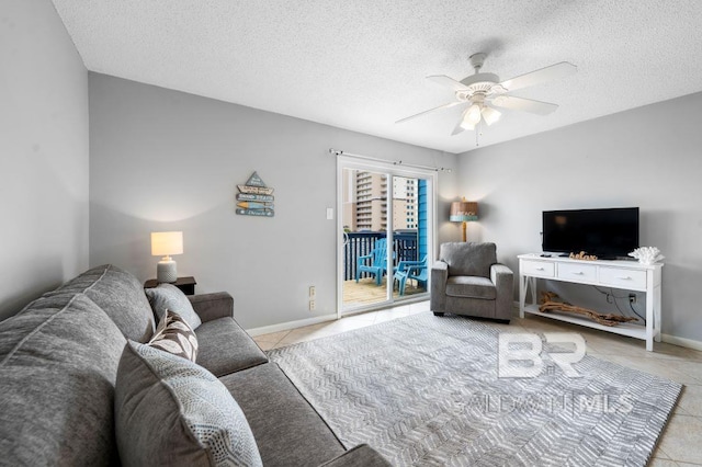 living room featuring tile patterned flooring, a textured ceiling, and ceiling fan