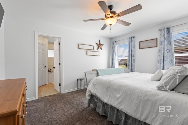 bedroom with ensuite bathroom, a ceiling fan, baseboards, and carpet floors