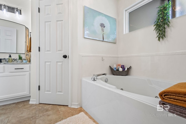 full bathroom featuring tile patterned floors, a jetted tub, and vanity