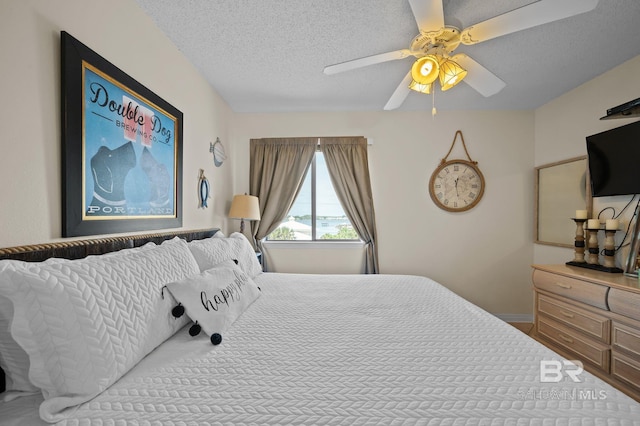 bedroom featuring a textured ceiling and ceiling fan