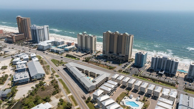 view of urban area with expansive coastline and a pool