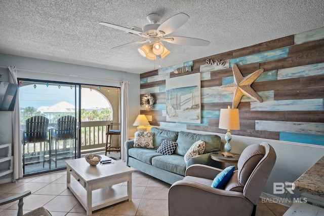 930 W Beach Blvd Unit 202, Gulf Shores, AL 36542 - living area featuring ceiling fan, a textured ceiling, tile patterned floors, and wood walls