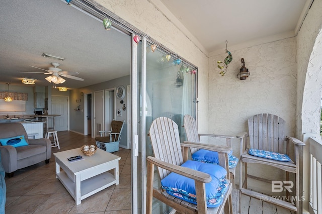 sunroom featuring ceiling fan