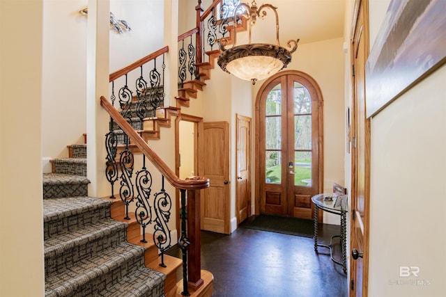 13897 Fish River Acres Cir, Foley, AL 36535 - foyer entrance featuring a high ceiling, finished concrete floors, stairs, and arched walkways