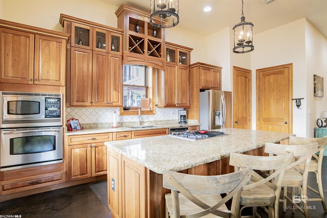 13897 Fish River Acres Cir, Foley, AL 36535 - kitchen featuring appliances with stainless steel finishes, a sink, tasteful backsplash, a center island, and a breakfast bar
