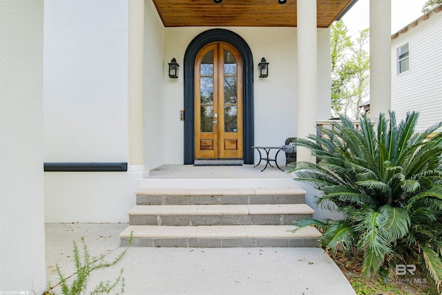 13897 Fish River Acres Cir, Foley, AL 36535 - doorway to property with stucco siding, french doors, and covered porch
