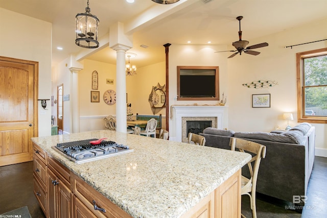 13897 Fish River Acres Cir, Foley, AL 36535 - kitchen featuring open floor plan, gas cooktop, a glass covered fireplace, a ceiling fan, and ornate columns