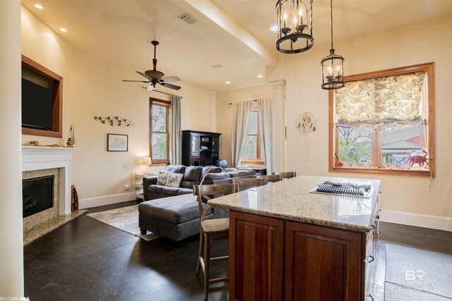 13897 Fish River Acres Cir, Foley, AL 36535 - kitchen with baseboards, a high end fireplace, ceiling fan, recessed lighting, and a center island