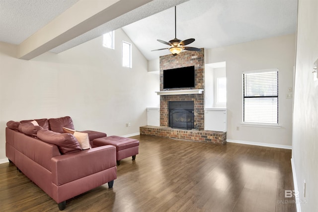 living room with vaulted ceiling, a brick fireplace, dark wood-type flooring, and a wealth of natural light