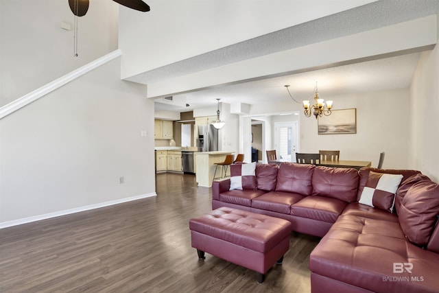 living room featuring dark hardwood / wood-style flooring and ceiling fan with notable chandelier