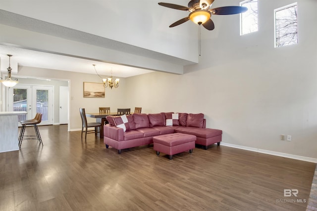 living room featuring french doors, plenty of natural light, dark hardwood / wood-style flooring, and ceiling fan with notable chandelier