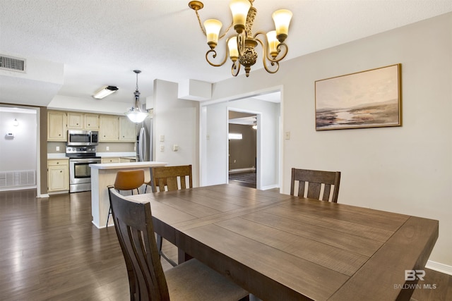 dining area with dark hardwood / wood-style floors and a notable chandelier