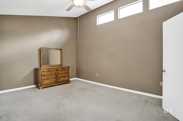 spare room featuring light carpet and ceiling fan