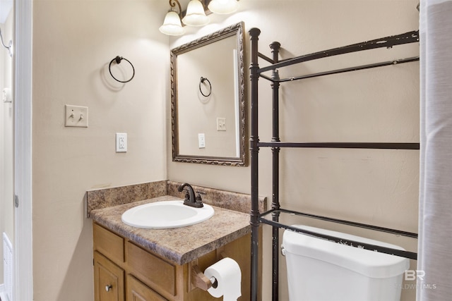 bathroom featuring vanity and toilet