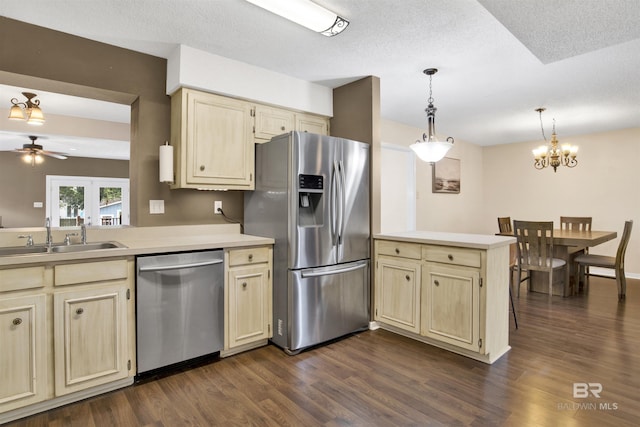 kitchen with sink, dark hardwood / wood-style flooring, hanging light fixtures, kitchen peninsula, and stainless steel appliances