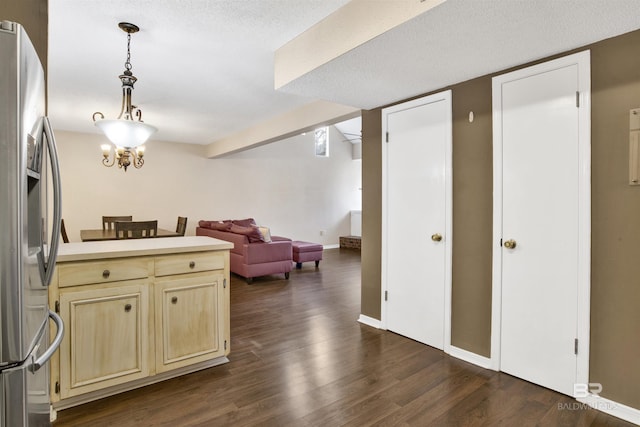 kitchen featuring an inviting chandelier, hanging light fixtures, dark hardwood / wood-style floors, stainless steel refrigerator with ice dispenser, and a textured ceiling