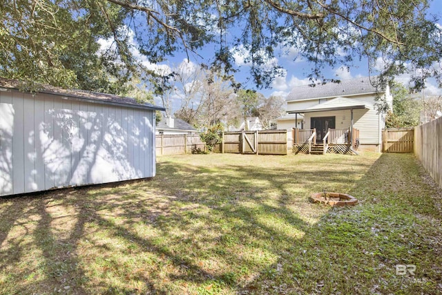 view of yard featuring a wooden deck and an outdoor fire pit