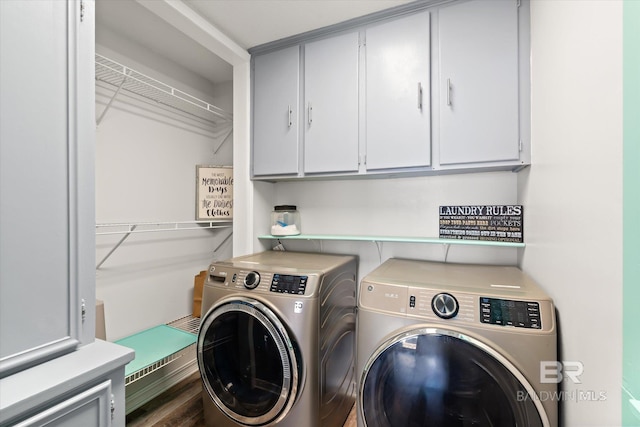 laundry area featuring cabinet space, independent washer and dryer, and wood finished floors