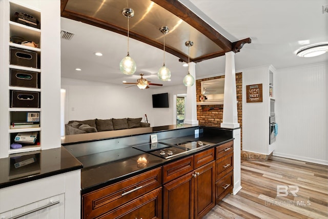 kitchen featuring light wood-style floors, black electric cooktop, dark countertops, and ceiling fan