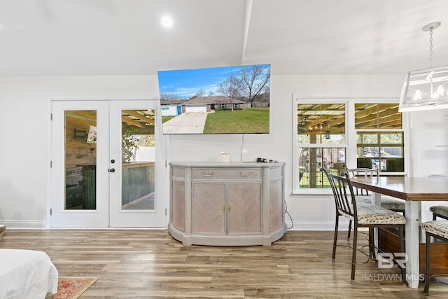 interior space featuring french doors, baseboards, and wood finished floors