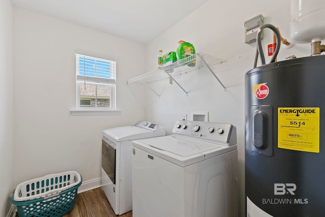 washroom with wood finished floors, baseboards, laundry area, water heater, and washing machine and dryer