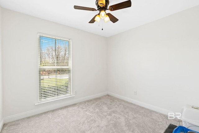 carpeted spare room with baseboards and ceiling fan