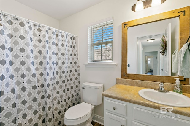 bathroom featuring a shower with curtain, toilet, and vanity