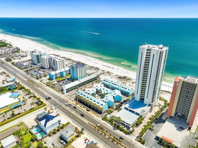 drone / aerial view featuring a water view and a view of the beach