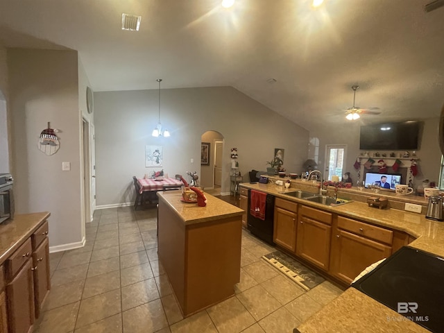 kitchen with sink, pendant lighting, vaulted ceiling, a kitchen island, and black appliances