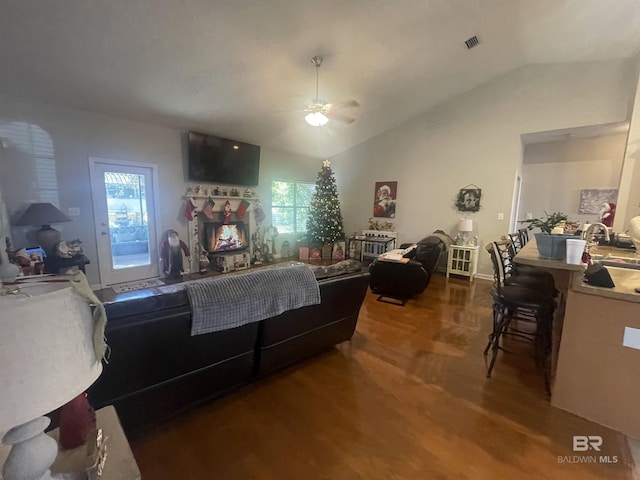 bedroom featuring hardwood / wood-style floors, ceiling fan, vaulted ceiling, and multiple windows