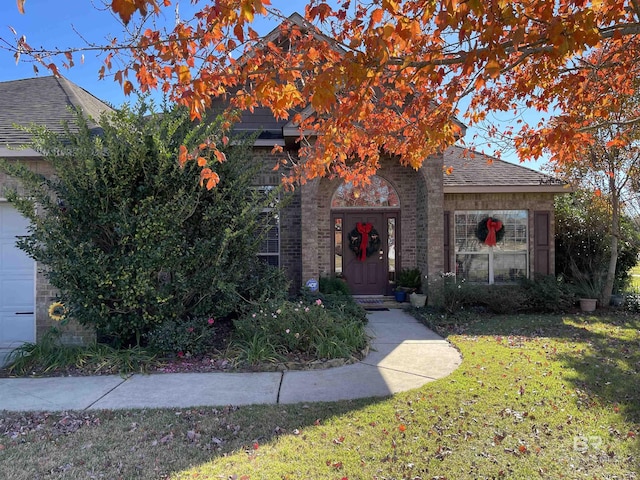 obstructed view of property featuring a front lawn