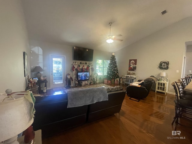 living room with ceiling fan, wood-type flooring, and vaulted ceiling