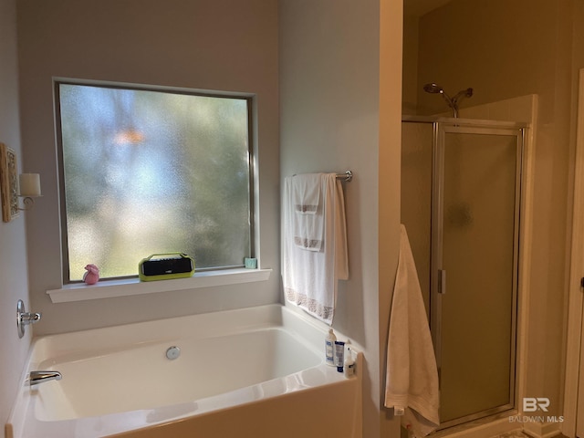 bathroom with a healthy amount of sunlight and plus walk in shower