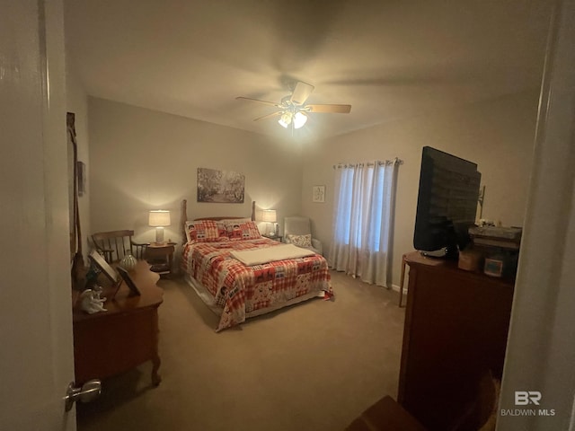 bedroom featuring ceiling fan and carpet