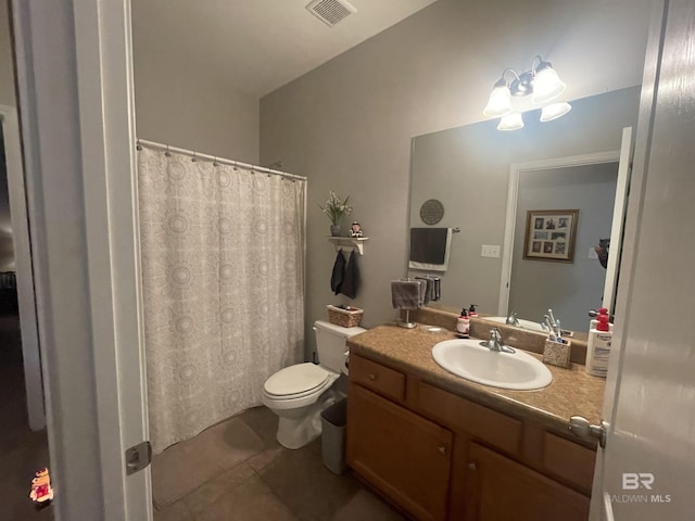 bathroom with tile patterned flooring, vanity, and toilet