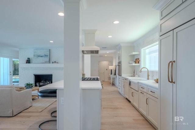 kitchen with plenty of natural light, decorative backsplash, white cabinetry, and sink