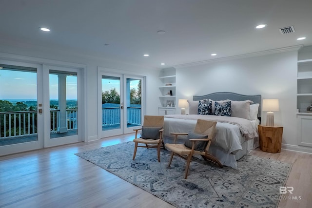 bedroom featuring french doors, light wood-type flooring, access to outside, and crown molding